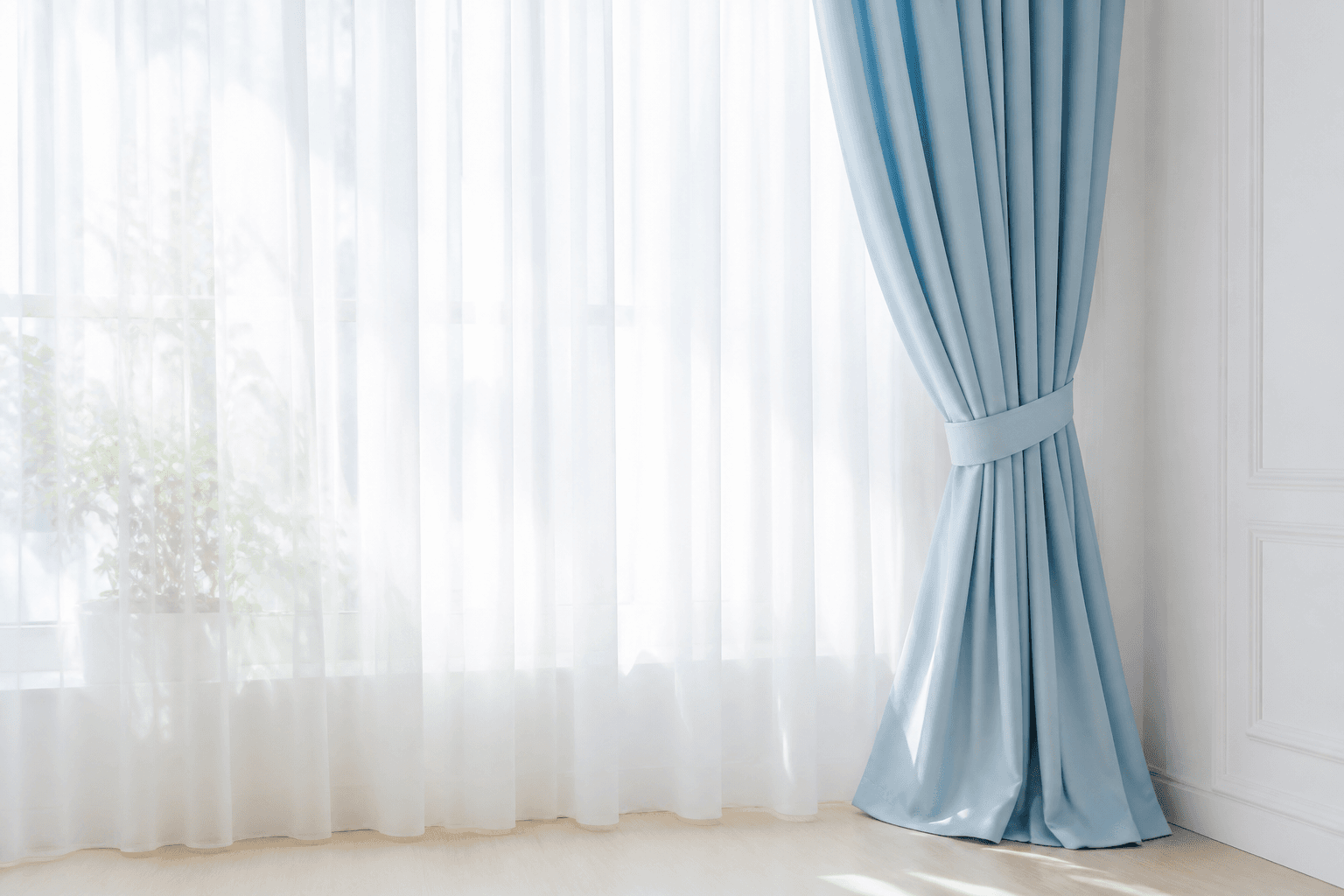 Soft white and sky-blue curtains hanging neatly